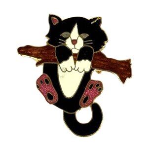 Black and white metal and cloisonne cat brooch.